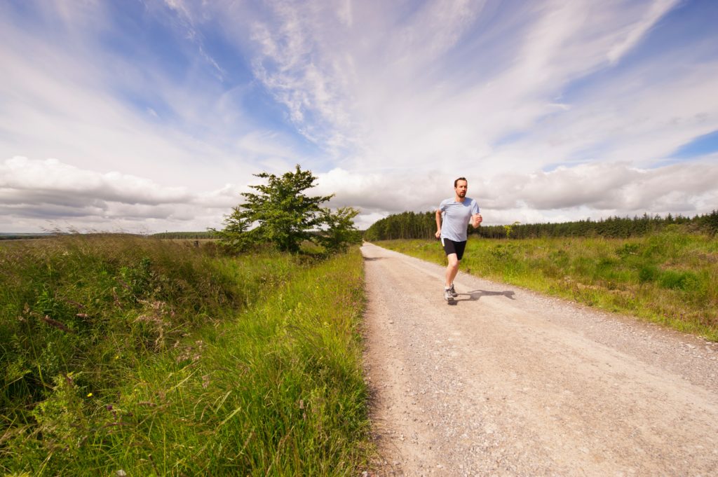 man-running-down-country-road